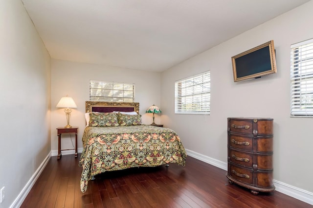 bedroom featuring hardwood / wood-style flooring and baseboards