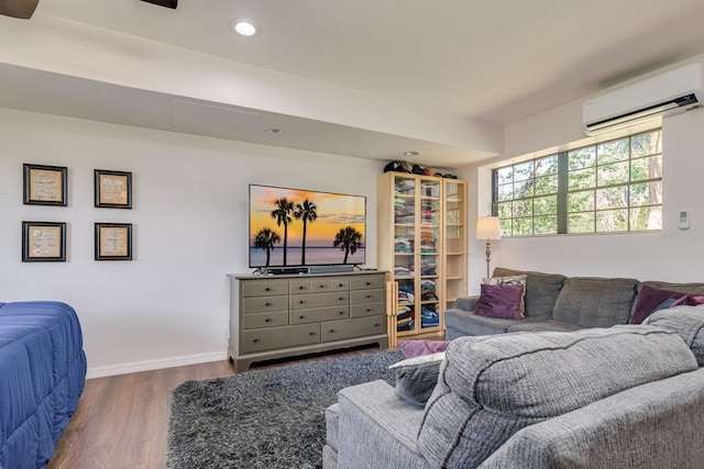 living room with recessed lighting, baseboards, an AC wall unit, and wood finished floors