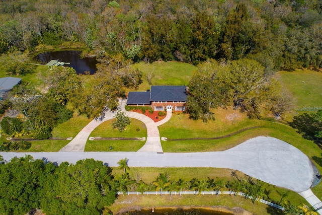 drone / aerial view with a wooded view