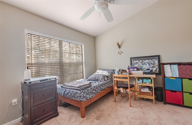 bedroom featuring ceiling fan, vaulted ceiling, and light colored carpet