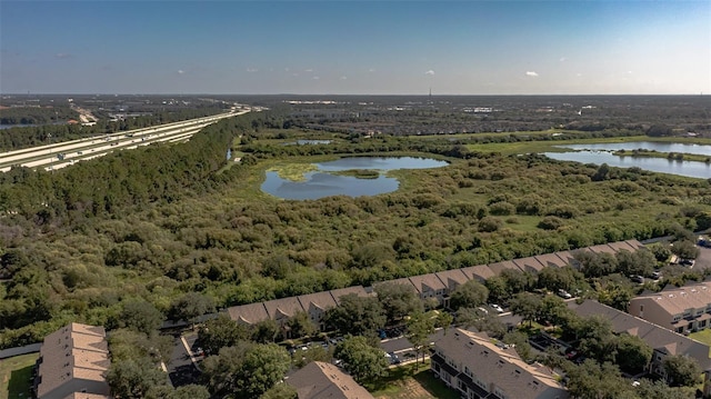 birds eye view of property with a water view and a view of trees