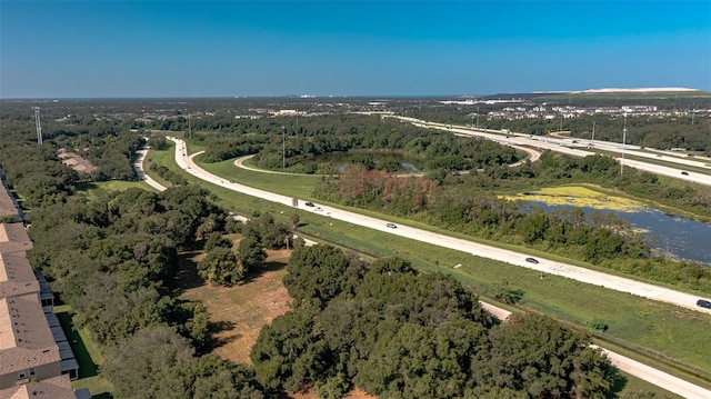 aerial view featuring a water view and a wooded view