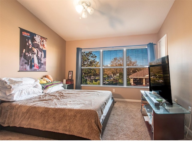 carpeted bedroom with vaulted ceiling and baseboards