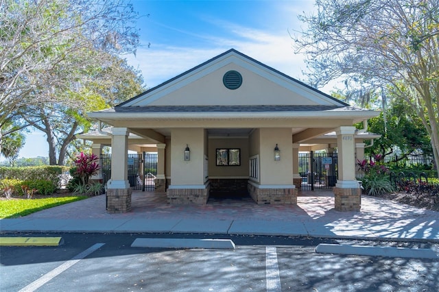 view of home's community with uncovered parking, a gate, and fence