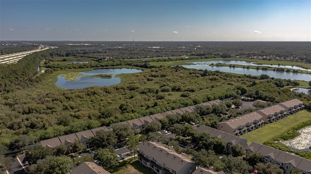 birds eye view of property with a water view and a forest view