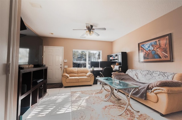 living area with a ceiling fan and light tile patterned floors