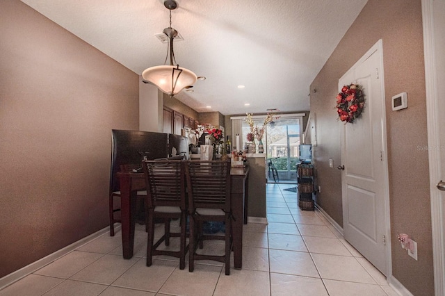 dining area featuring baseboards and light tile patterned floors