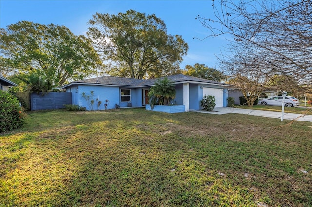 ranch-style home with driveway, stucco siding, an attached garage, fence, and a front yard