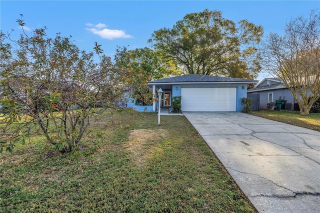 view of front of property with driveway, stucco siding, a garage, and a front yard