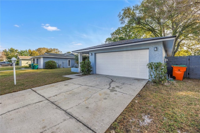 single story home featuring a garage, a front lawn, concrete driveway, and stucco siding