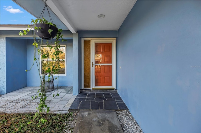 doorway to property with stucco siding