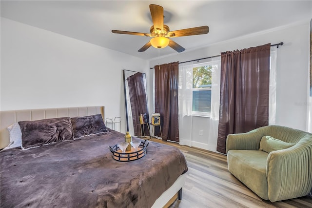 bedroom featuring a ceiling fan and wood finished floors