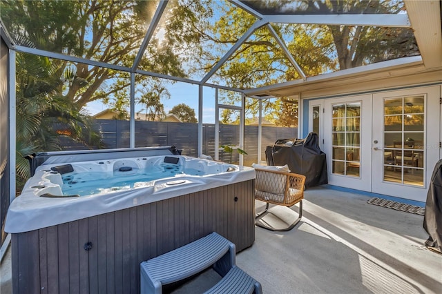 sunroom with french doors and a jacuzzi