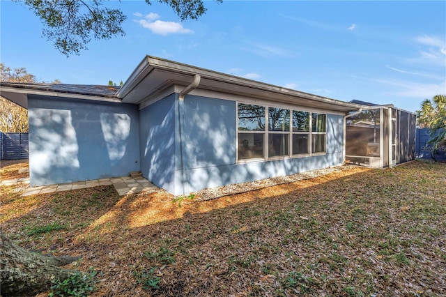 view of side of property with a sunroom