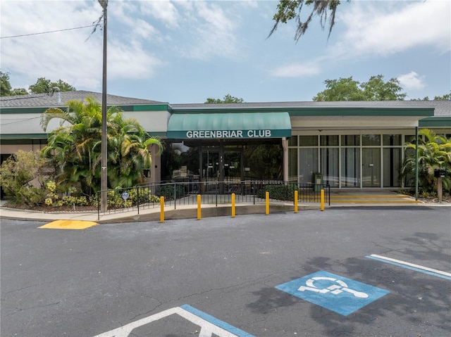 view of property featuring uncovered parking and fence