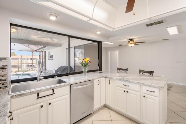 kitchen with visible vents, a sink, white cabinetry, dishwasher, and ceiling fan