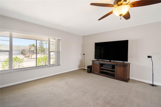 living room with light carpet, a ceiling fan, and baseboards