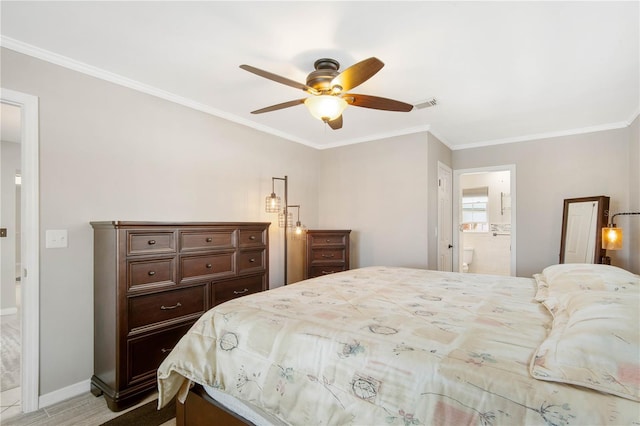 bedroom with visible vents, ornamental molding, and ensuite bathroom