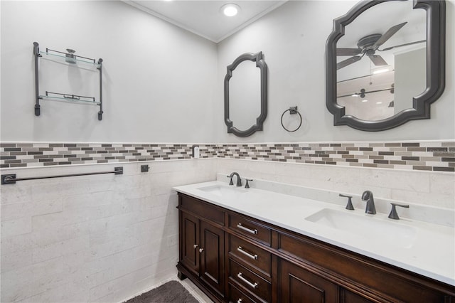 bathroom featuring double vanity, tile walls, wainscoting, and a sink