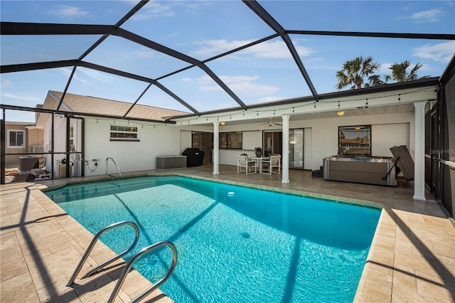 outdoor pool with glass enclosure, a patio, and ceiling fan