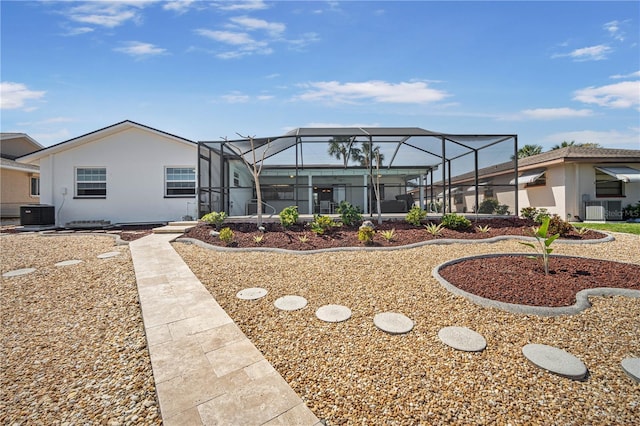 back of property with cooling unit and a lanai