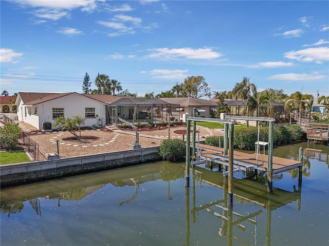 view of dock featuring a lanai, a water view, a residential view, and boat lift