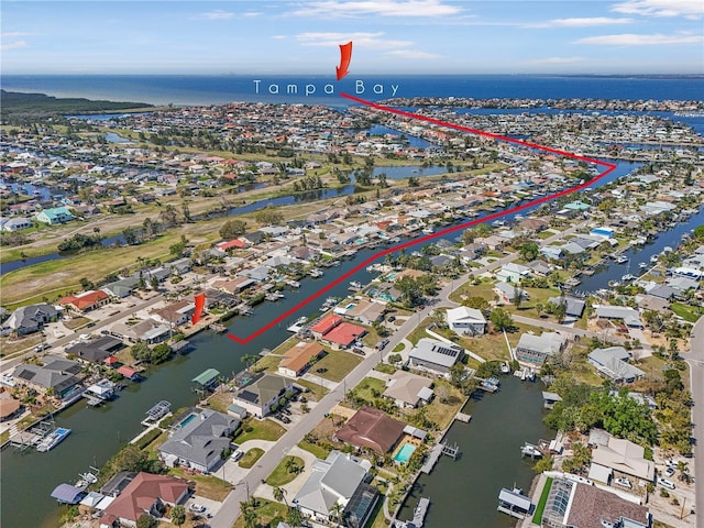 drone / aerial view featuring a residential view and a water view