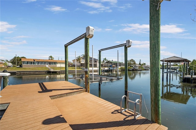 view of dock featuring boat lift and a water view