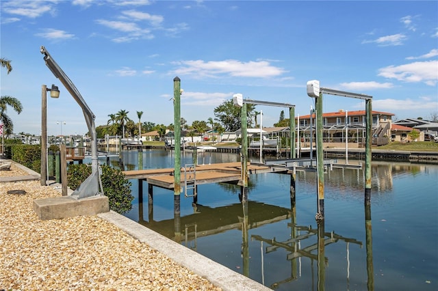 view of dock with boat lift and a water view