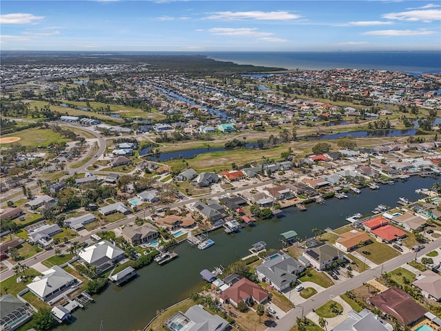 drone / aerial view with a water view and a residential view