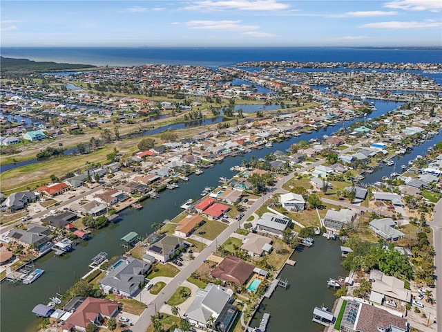 birds eye view of property featuring a water view and a residential view