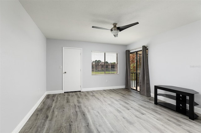 unfurnished bedroom with a ceiling fan, access to outside, baseboards, and wood finished floors