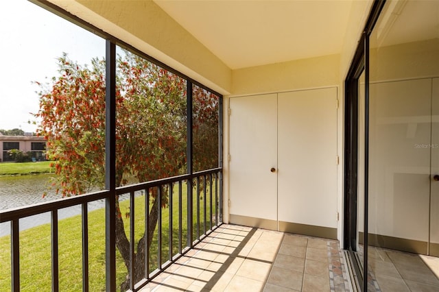 unfurnished sunroom featuring a water view