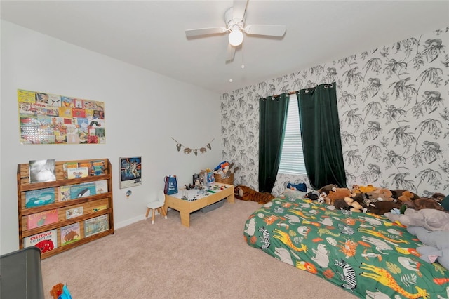 carpeted bedroom featuring wallpapered walls and a ceiling fan