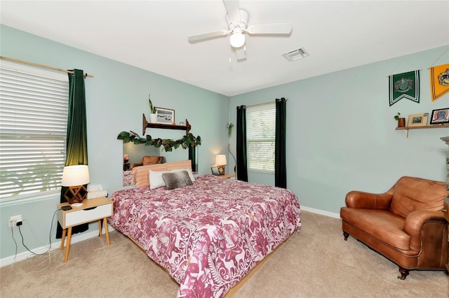 bedroom with a ceiling fan, carpet flooring, visible vents, and baseboards