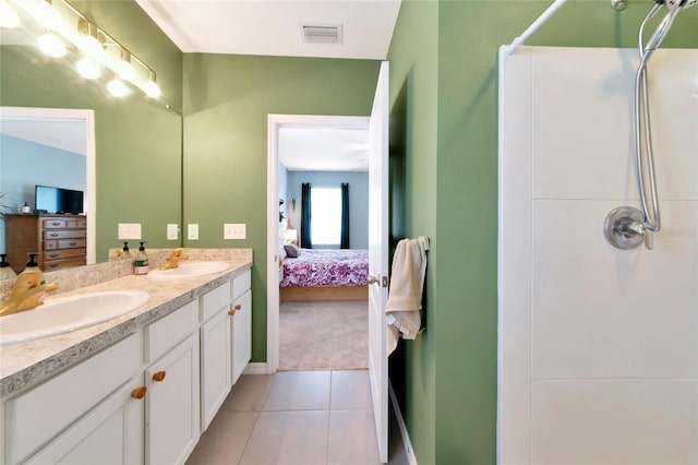 ensuite bathroom featuring a shower, visible vents, a sink, and ensuite bath