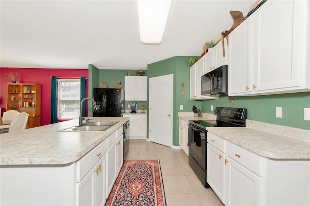 kitchen featuring light tile patterned floors, light countertops, black appliances, white cabinetry, and a sink