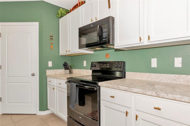 kitchen with white cabinets, black appliances, light tile patterned floors, and light countertops