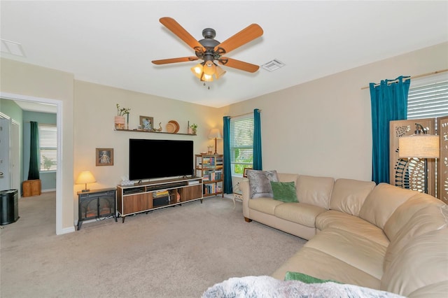 living area with plenty of natural light, carpet flooring, and visible vents