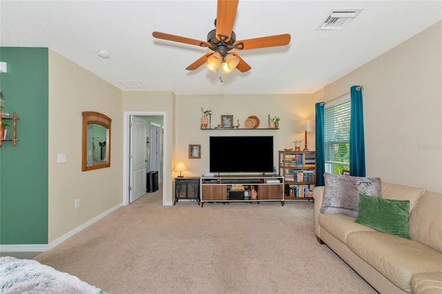 carpeted living room with ceiling fan, visible vents, and baseboards