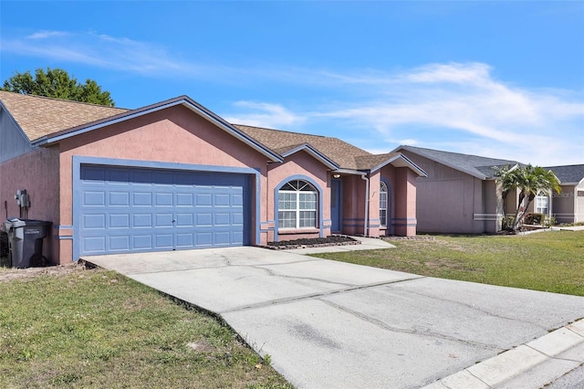 ranch-style home with roof with shingles, stucco siding, a front yard, a garage, and driveway