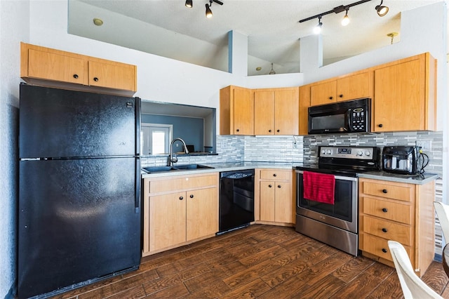 kitchen featuring dark wood finished floors, lofted ceiling, light brown cabinetry, black appliances, and a sink