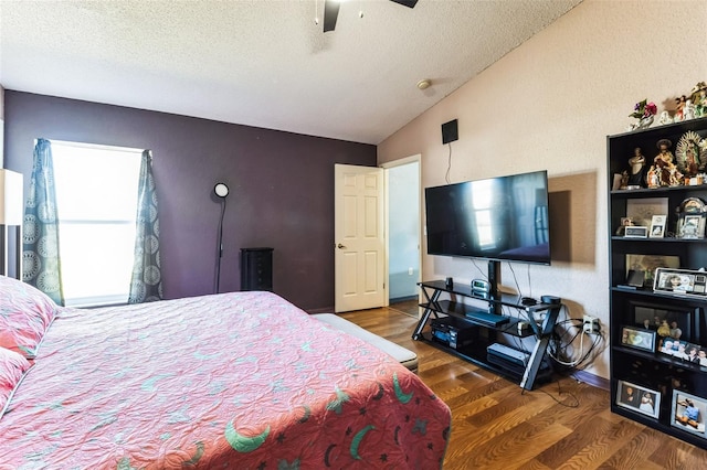 bedroom with lofted ceiling, ceiling fan, a textured ceiling, wood finished floors, and baseboards