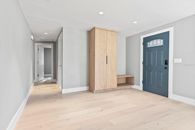 entryway featuring light wood finished floors, baseboards, and recessed lighting