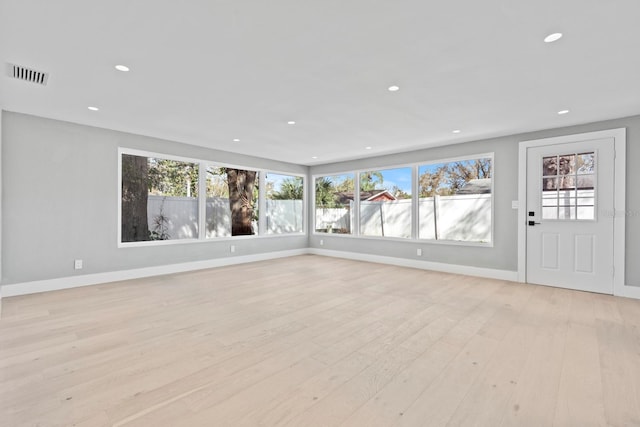 unfurnished living room with light wood-style flooring, visible vents, baseboards, and recessed lighting