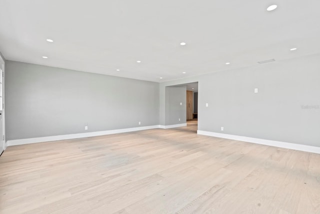 unfurnished room with recessed lighting, baseboards, and light wood finished floors