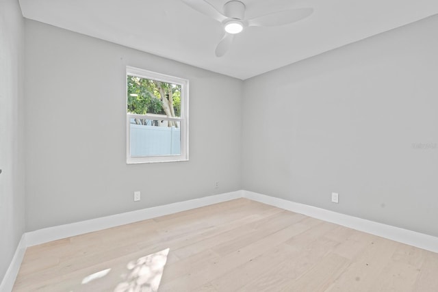 empty room with baseboards and wood finished floors