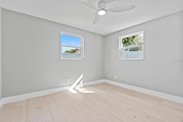 spare room featuring ceiling fan, wood finished floors, and baseboards