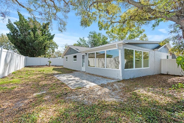 back of house with a patio area, a fenced backyard, and stucco siding