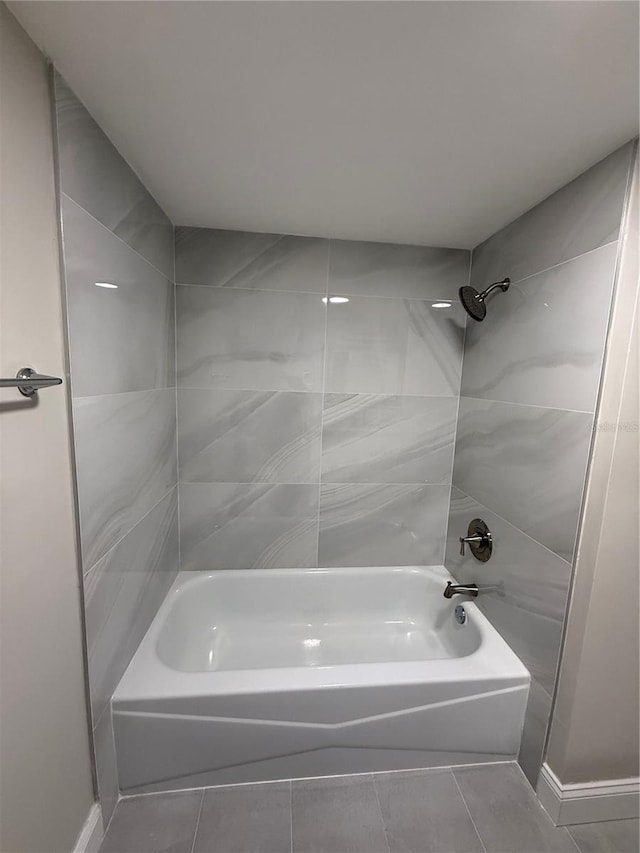 1000 49th St N Unit 309, Saint Petersburg, FL 33710 - bathroom with washtub / shower combination and tile patterned floors